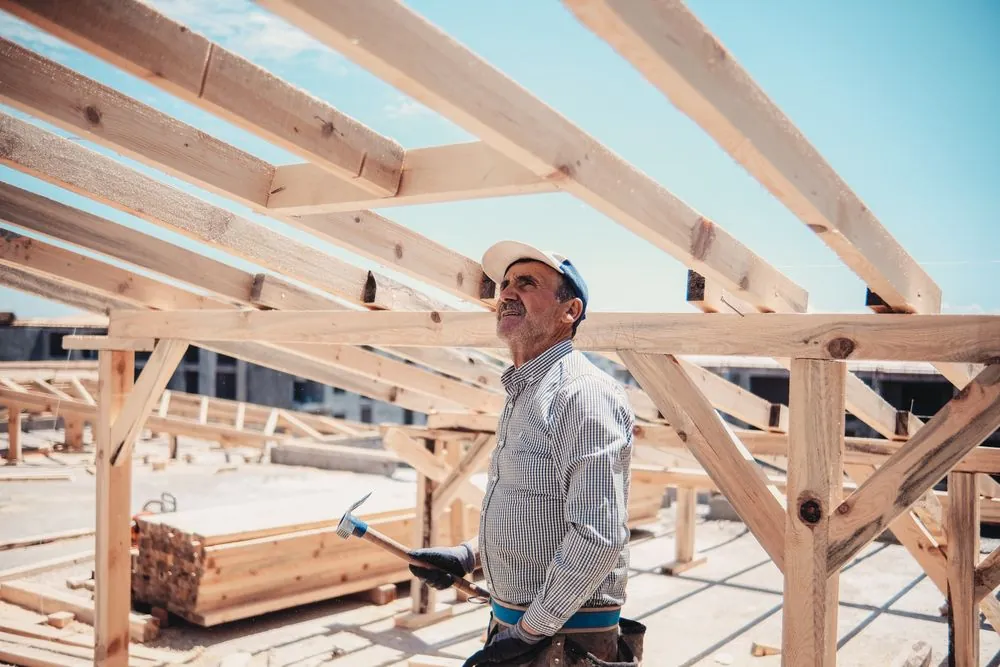 A builder working inside a timber frame