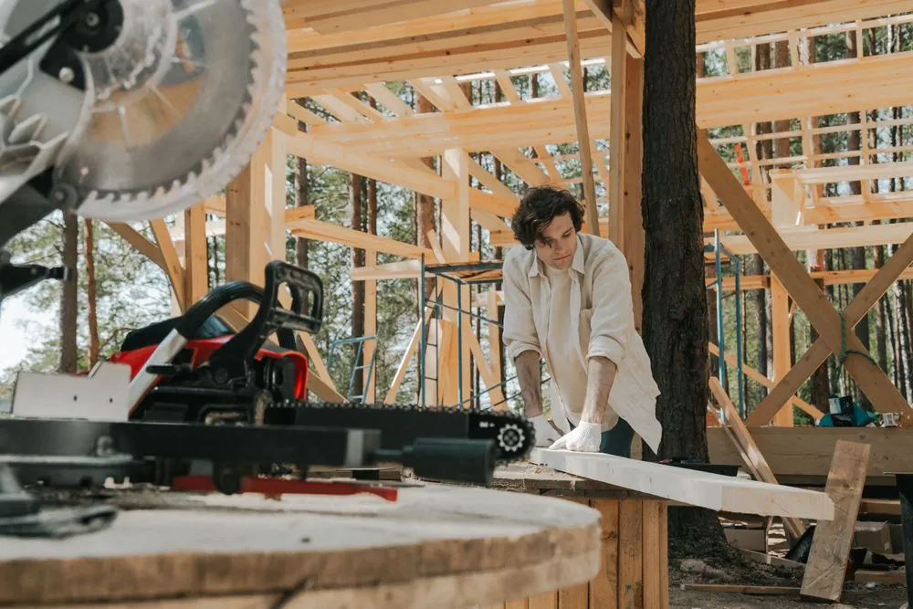A joiner cutting timber on a saw bench